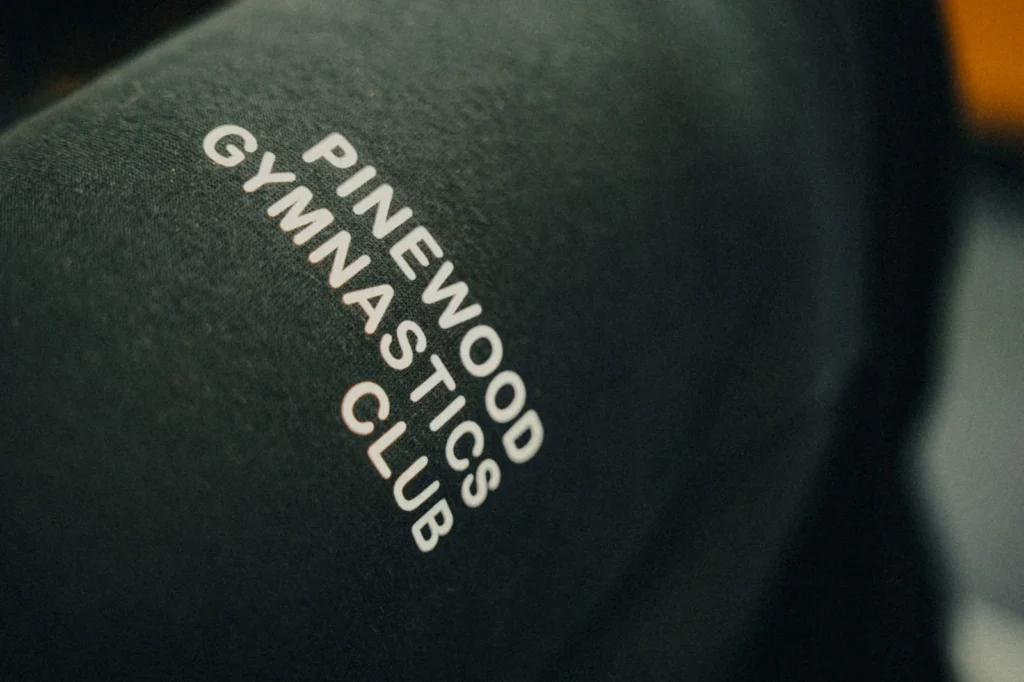 Close-up of custom printed dark fabric for Pinewood Gymnastics Club by Jammy Threads.