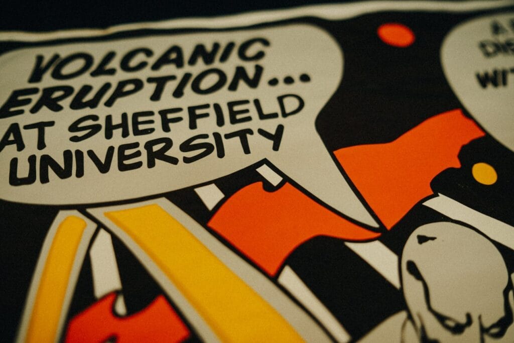 Close-up of a t-shirt print with text: 'VOLCANIC ERUPTION... AT SHEFFIELD UNIVERSITY