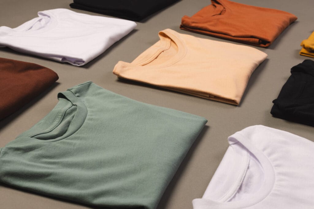 Neatly folded premium blank t-shirts in multiple colours for Jammy Threads collection.